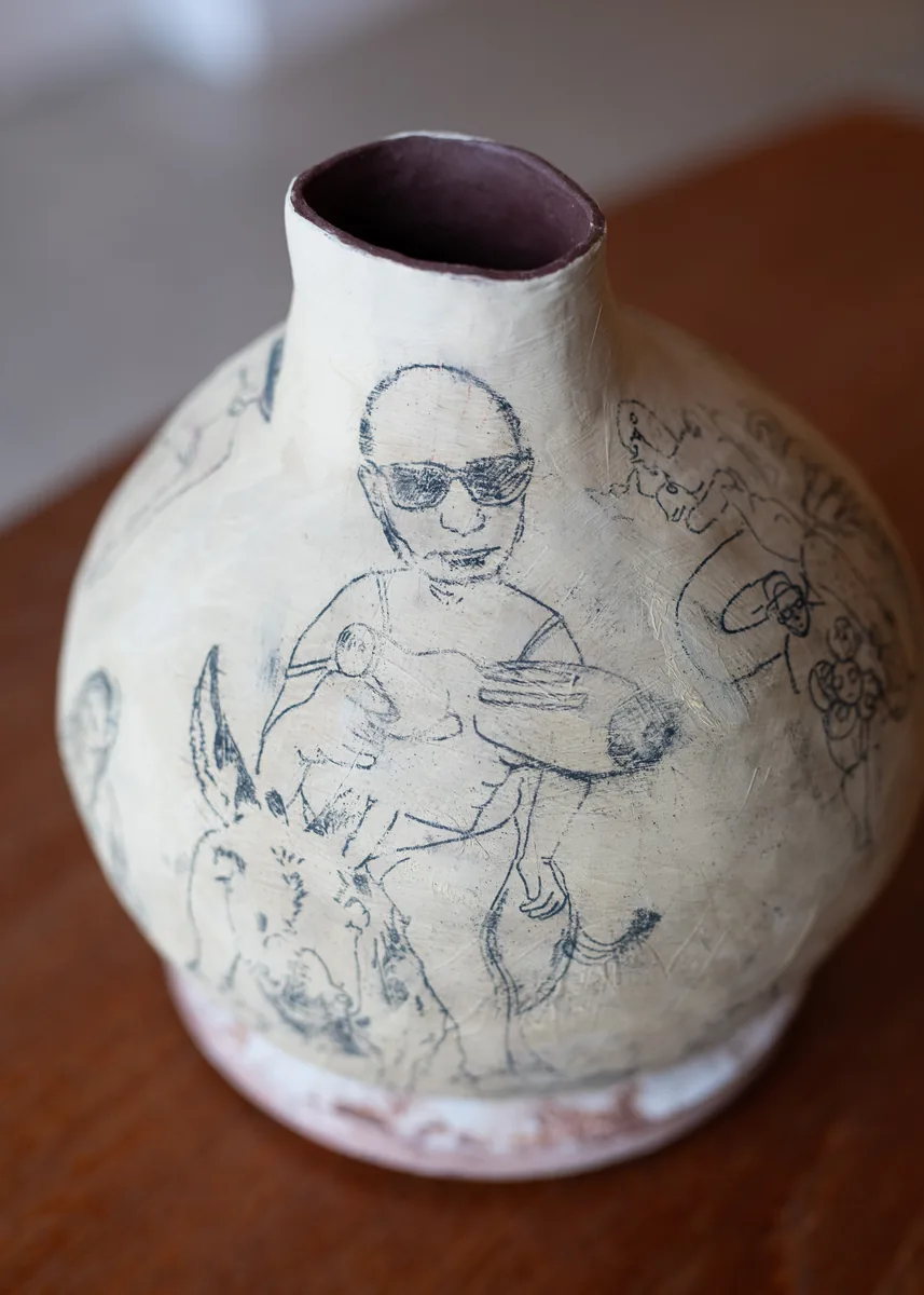 Figures drawn on a hand-built vessel